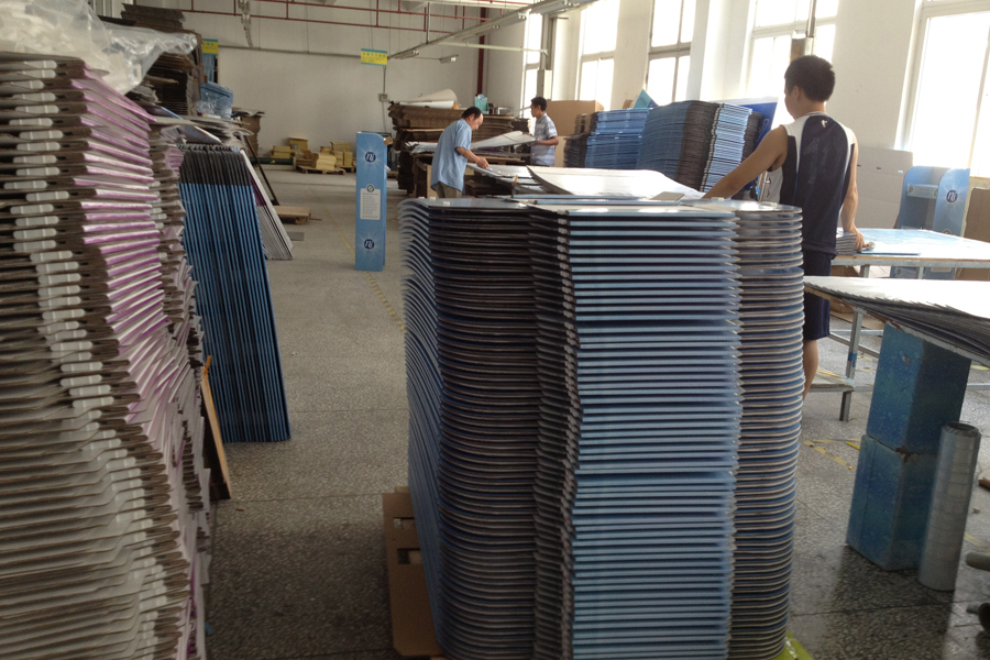 Holidaypac archive workplace photo showing people beside stacks of flat cardboard display components