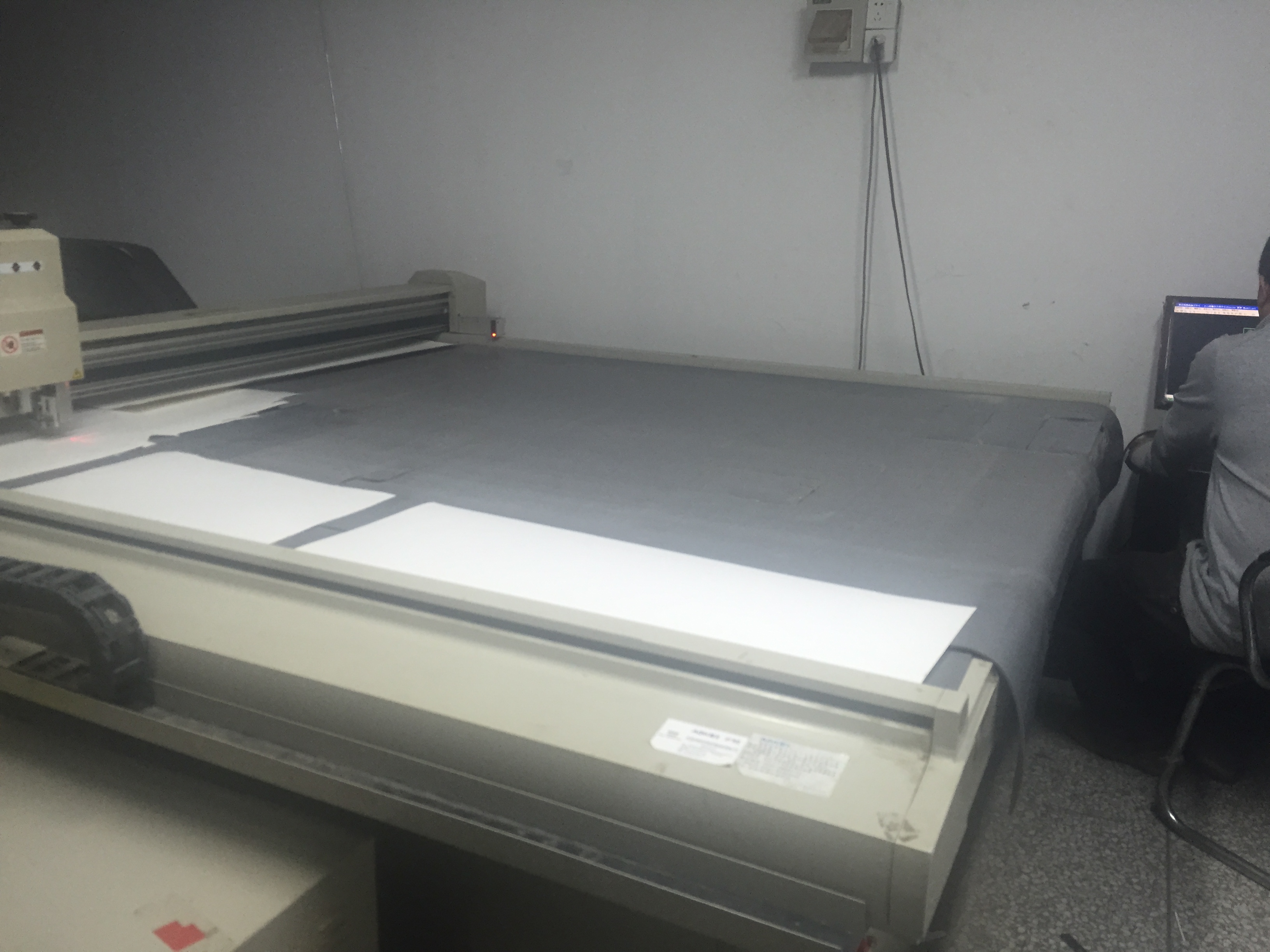 Holidaypac archive photo of a cardboard sample-cutting workstation with an operator