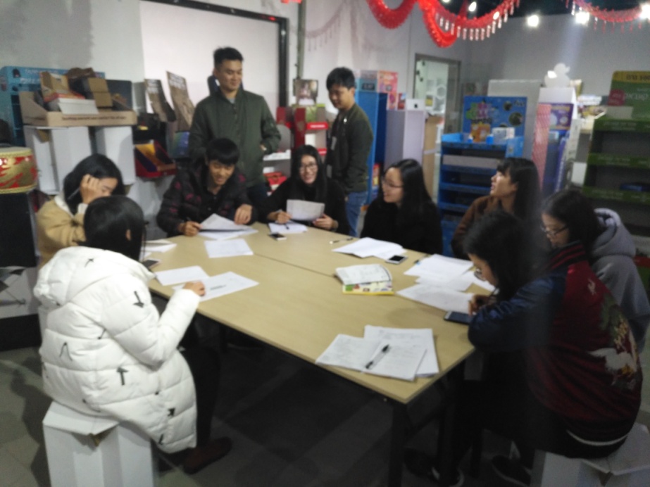 Holidaypac colleagues discussing packaging work around a table