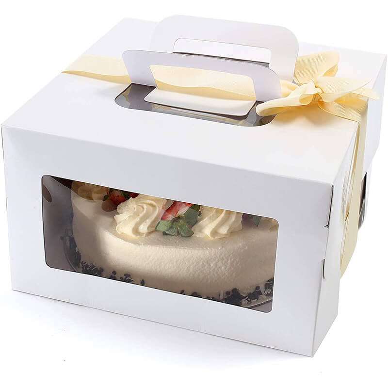 1.White cardboard cake box in hand