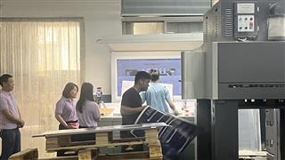 Printing equipment and people beside the sheet review station