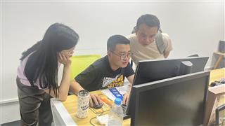 Office team looking at a computer screen at Holidaypac