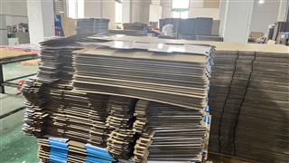 Stacks of shaped cardboard components in the Holidaypac workshop
