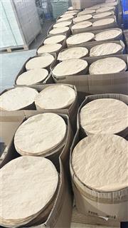 Stacks of circular paper blanks in protective sleeves