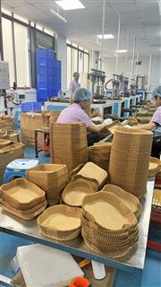 Round and rectangular formed paper pieces stacked in the workshop