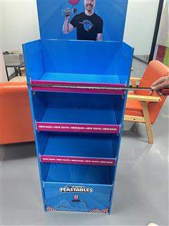 Front view of a Feastables chocolate stand with a horizontal ruler